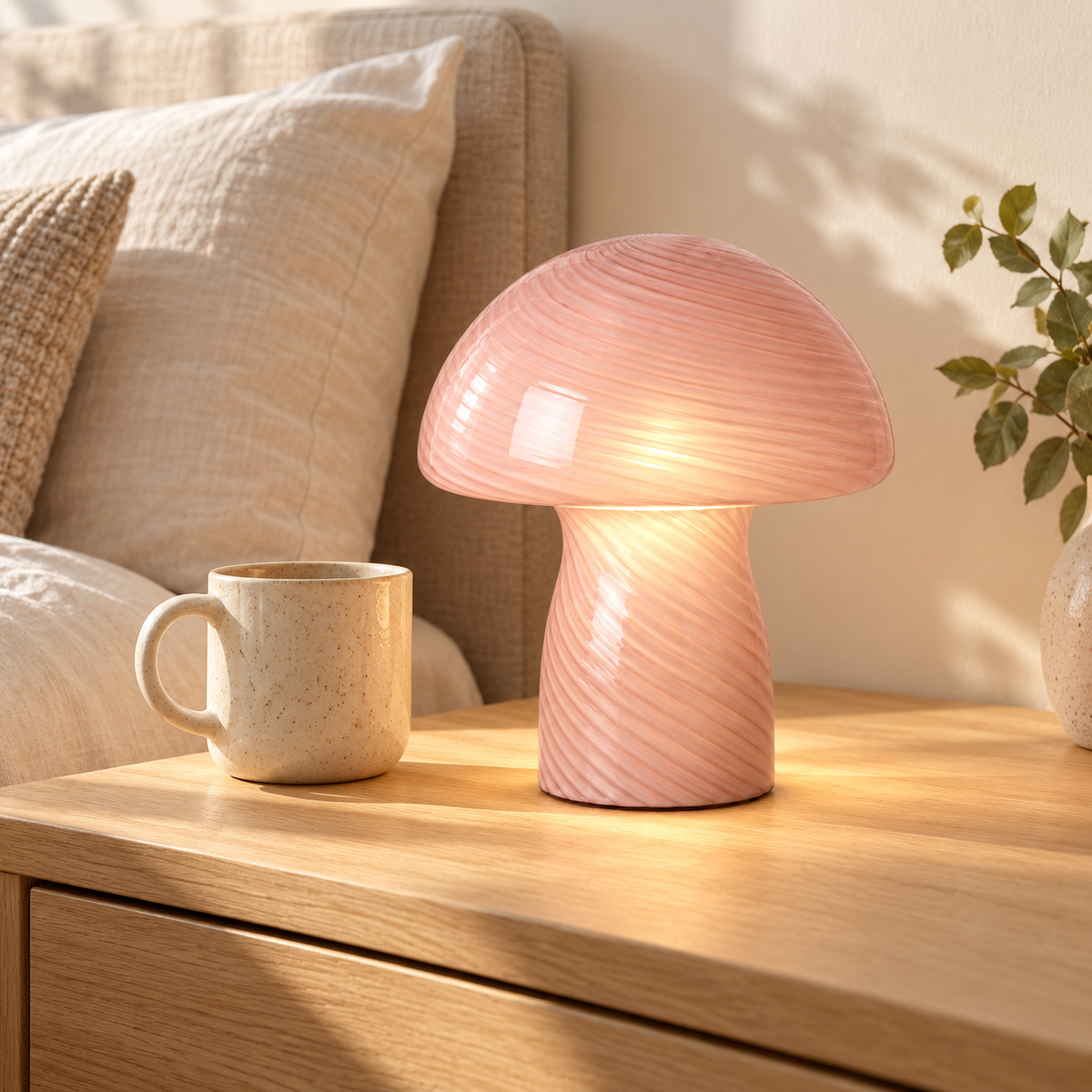 Margot Blush Pink mushroom lamp on a bedside table beside a mug