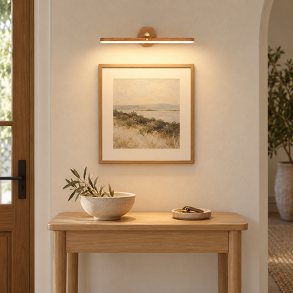 Haven Natural rechargeable wooden wall light above an entryway table and framed art, shown at realistic scale