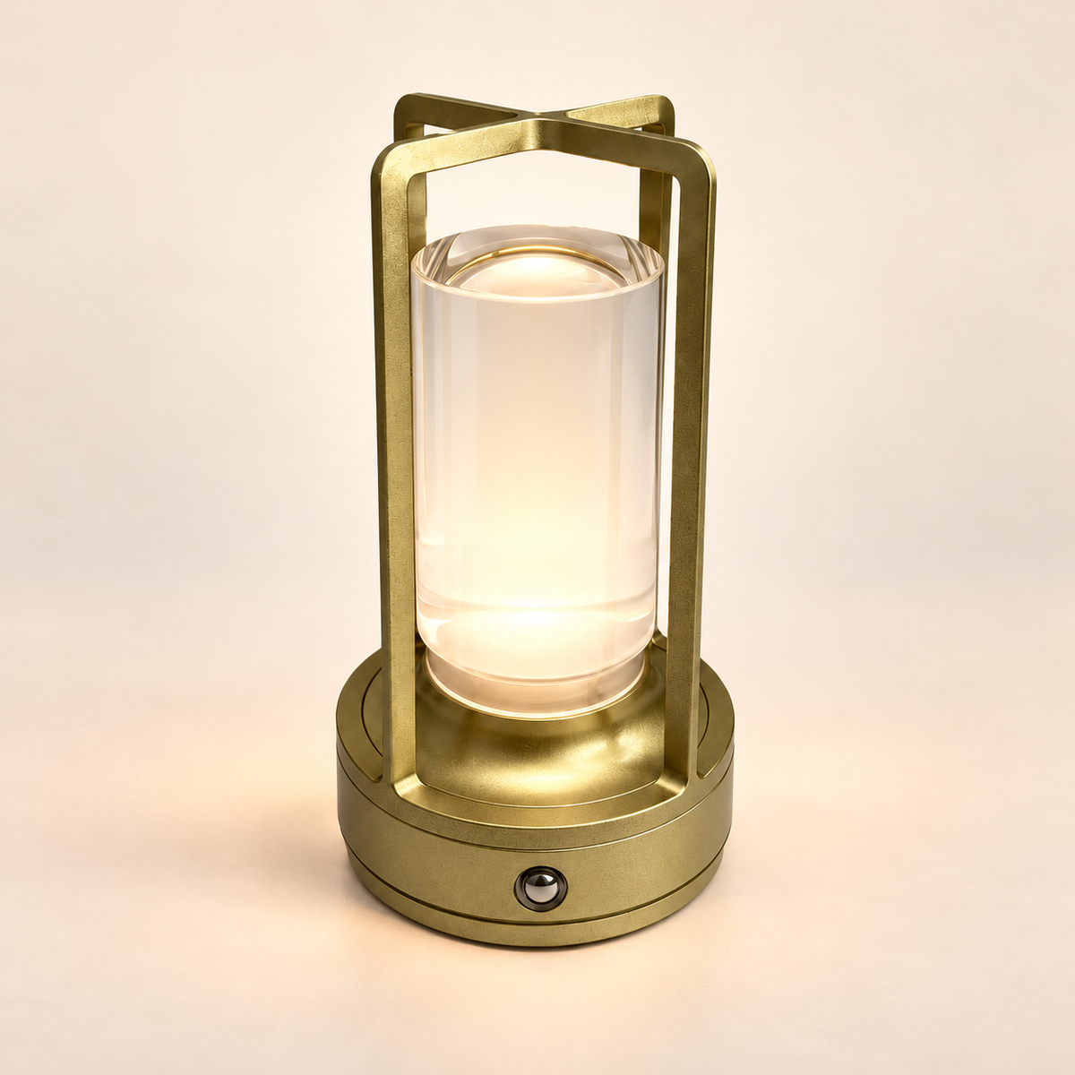 Noelle rechargeable metal table lamp in muted brushed gold on a warm ivory studio background.