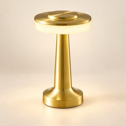 Solène gold rechargeable mushroom table lamp with a circular diffuser on a warm ivory background